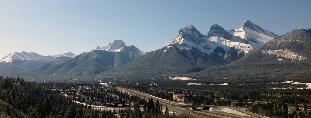 The Three Sisters mountains rise over Canmore, Alta. 