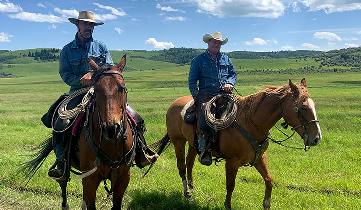 Ranching partner Joe Engelhart, and Roland Sappola, a Spruce Ranching Co-op owner on horseback at the ranch in southern Alberta. Photo by Naomi Louchouarn