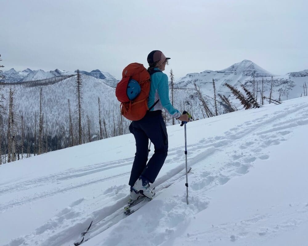 A skiier ascends a backcountry trail
