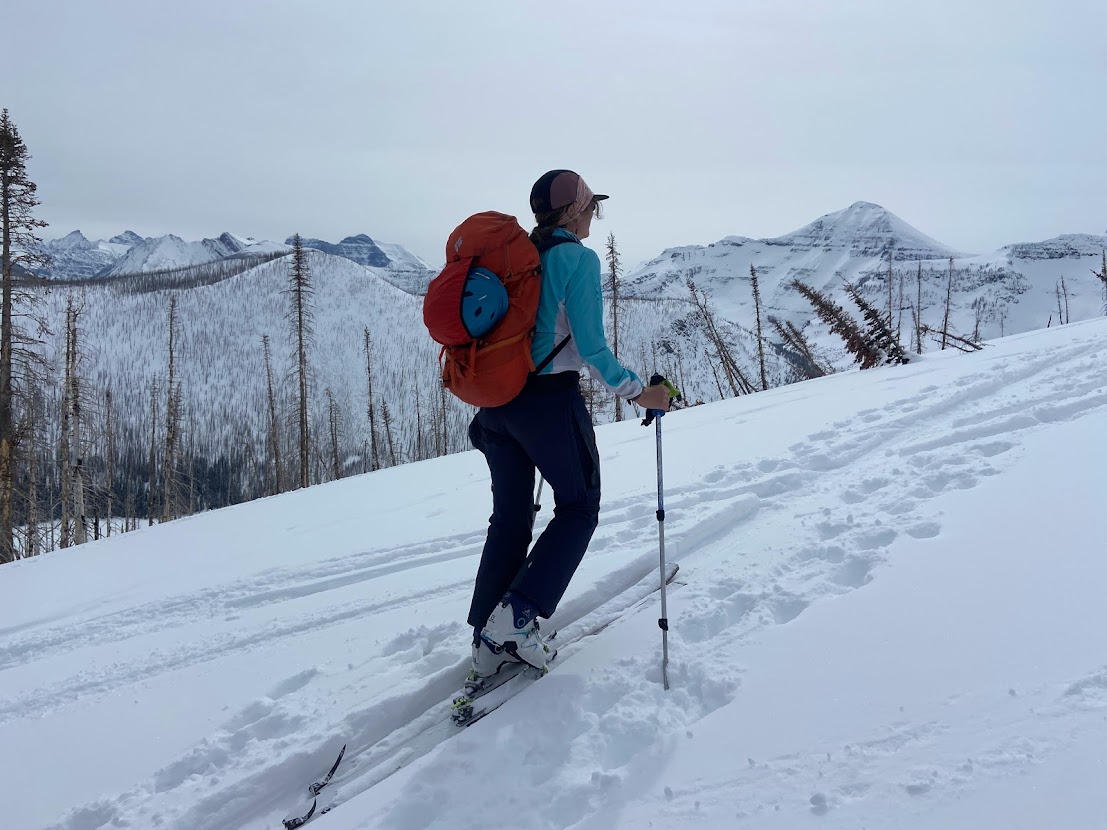 A skiier ascends a backcountry trail