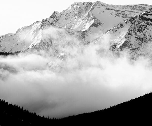 A black and white shot of an enormous mountain covered in snow