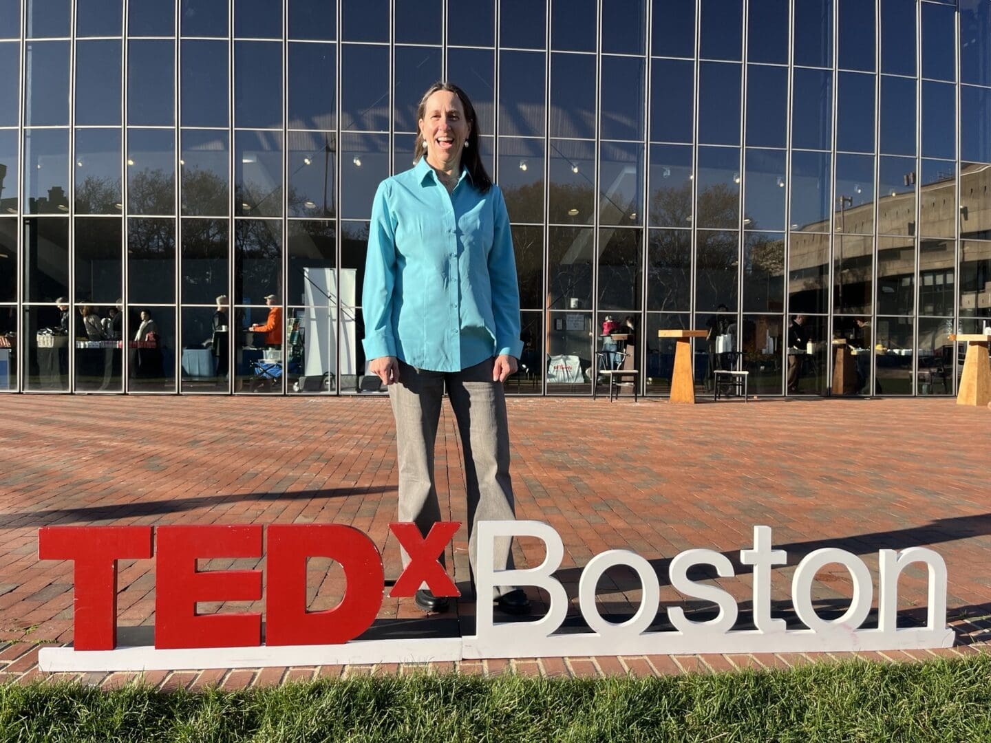 Y2Y's Dr. Jodi Hilty stands by a TedXBoston sign