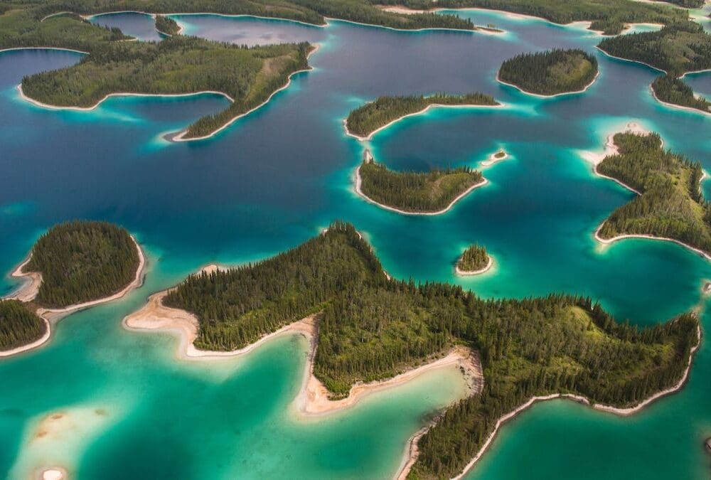 Tree-covered islands rise from turquoise waters.