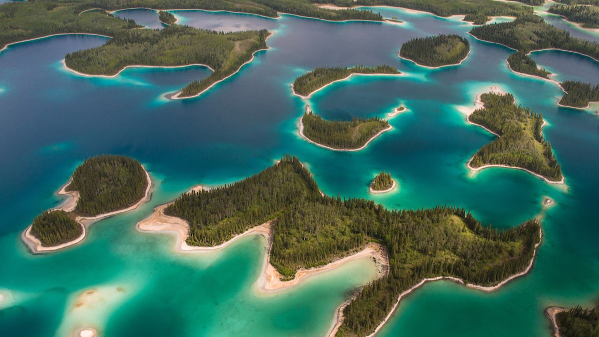 Tree-covered islands rise from turquoise waters.